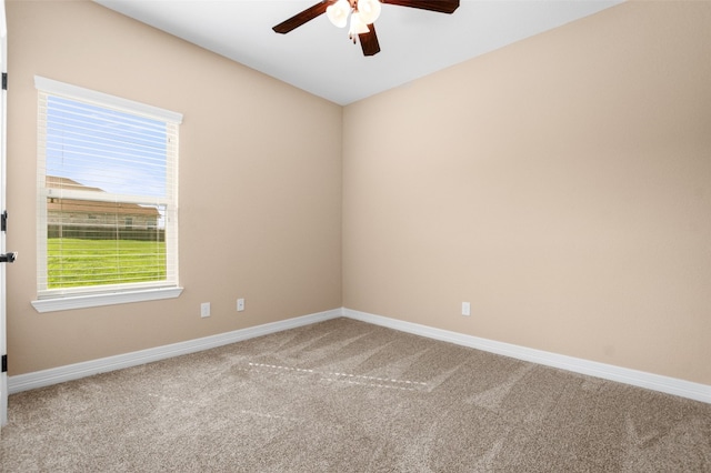 carpeted spare room featuring ceiling fan