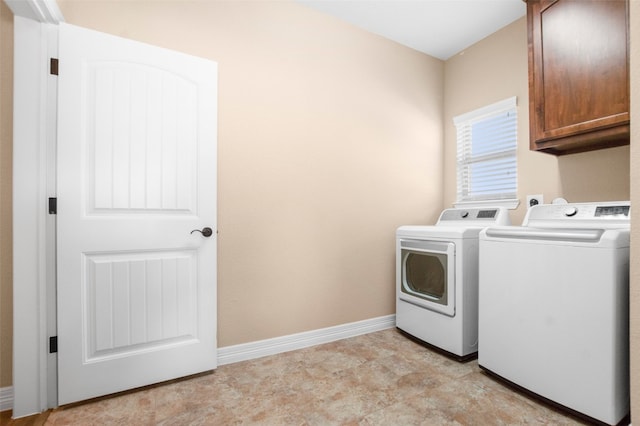 washroom with light tile flooring, independent washer and dryer, and cabinets