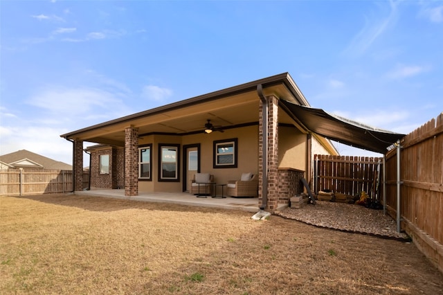 back of property featuring a patio area and ceiling fan