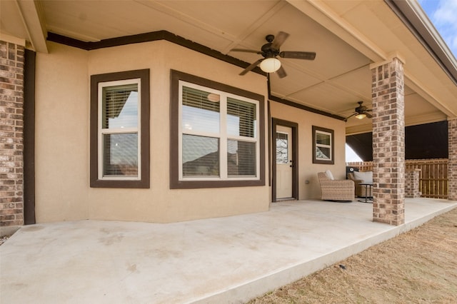 doorway to property featuring ceiling fan and a patio