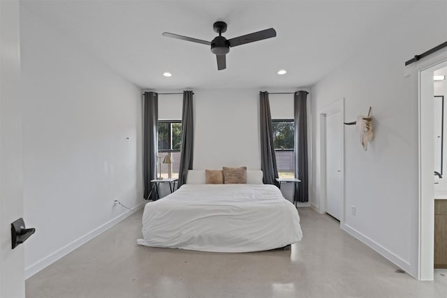 bedroom with a barn door and ceiling fan