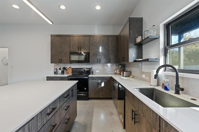 kitchen featuring sink, backsplash, dark brown cabinetry, and black appliances