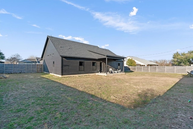 rear view of property with a lawn and a patio