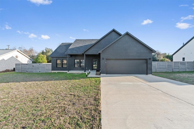 view of front of home with a garage and a front lawn