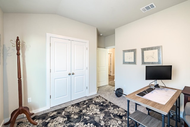 home office featuring lofted ceiling and light colored carpet