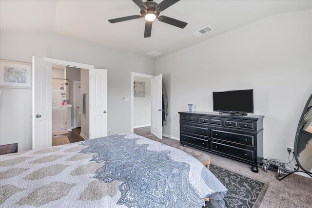 bedroom with vaulted ceiling, dark carpet, ensuite bath, and ceiling fan