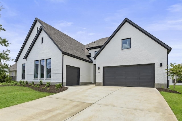 view of front of house featuring a garage and a front lawn