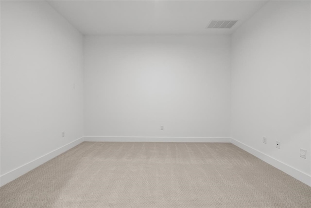 spare room featuring light colored carpet