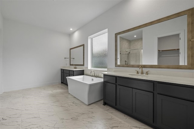 bathroom featuring vanity and shower with separate bathtub