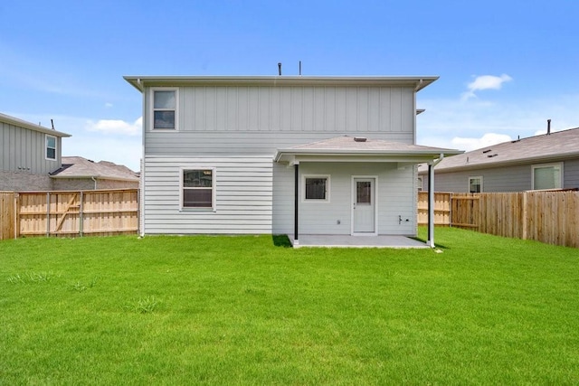 rear view of house with a lawn and a patio area