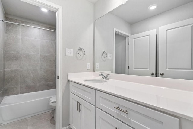 full bathroom featuring tiled shower / bath, vanity, and toilet