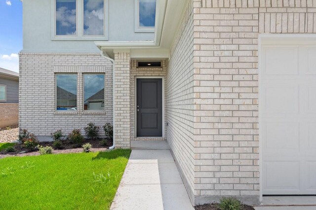 doorway to property featuring a lawn