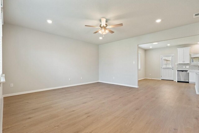 unfurnished living room with ceiling fan and light wood-type flooring