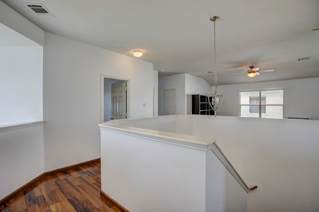 kitchen with baseboards, visible vents, light countertops, and dark wood-type flooring