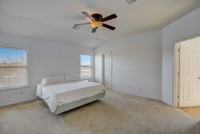 bedroom with lofted ceiling, light colored carpet, visible vents, ceiling fan, and baseboards