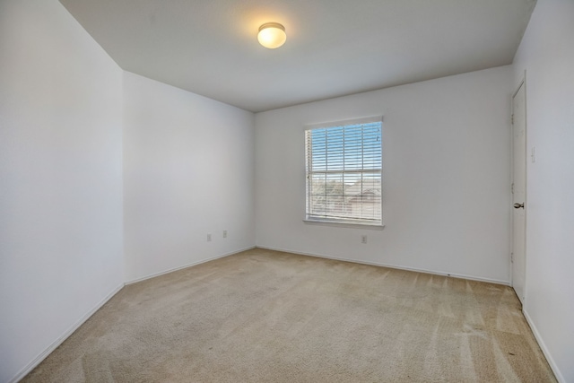 unfurnished room with light carpet