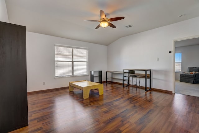 sitting room with lofted ceiling, wood finished floors, visible vents, baseboards, and a ceiling fan