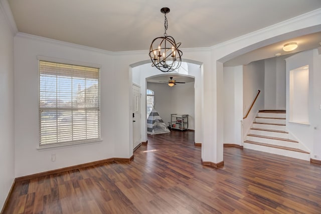 interior space with arched walkways, wood finished floors, stairs, and ornamental molding