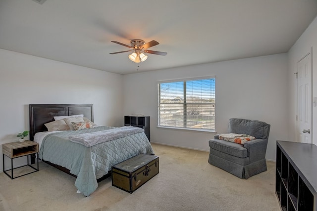 bedroom with baseboards, a ceiling fan, and light colored carpet