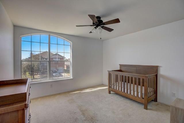 bedroom featuring ceiling fan and carpet