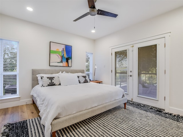 bedroom featuring access to exterior, ceiling fan, wood-type flooring, and french doors