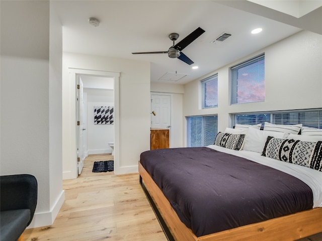 bedroom with connected bathroom, ceiling fan, and light hardwood / wood-style flooring