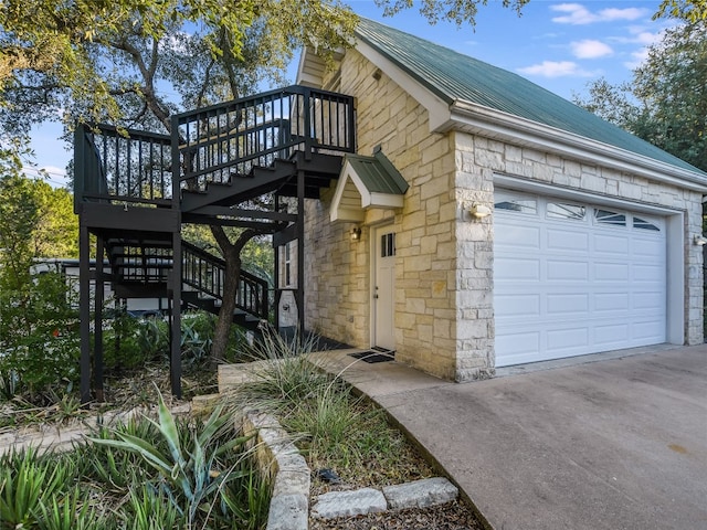 view of home's exterior with a deck and a garage