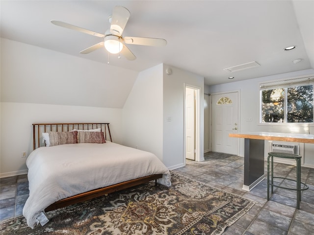 bedroom with ceiling fan, dark tile flooring, and vaulted ceiling