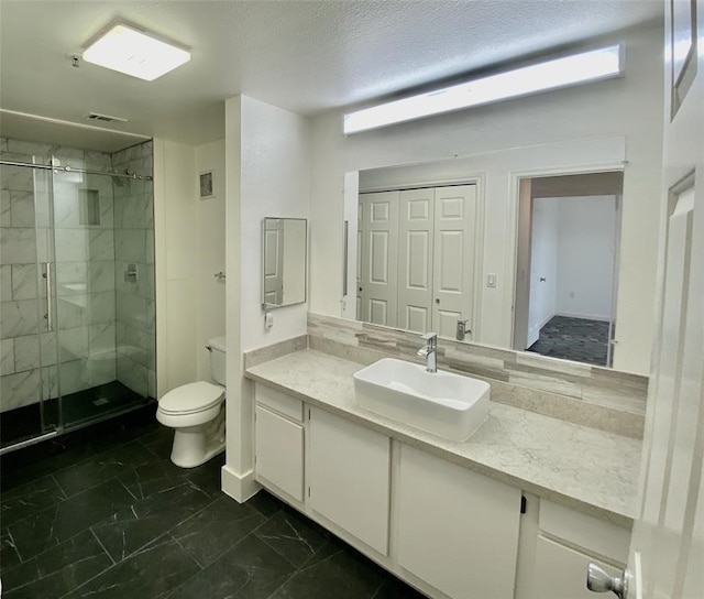 bathroom with toilet, a textured ceiling, vanity with extensive cabinet space, tile flooring, and an enclosed shower