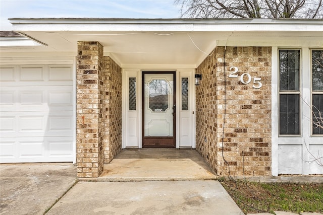 entrance to property featuring covered porch and a garage