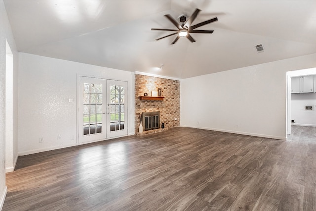 unfurnished living room with lofted ceiling, ceiling fan, a fireplace, french doors, and dark hardwood / wood-style flooring