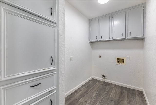 washroom featuring dark hardwood / wood-style flooring, hookup for an electric dryer, cabinets, and hookup for a washing machine