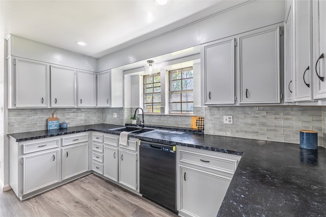 kitchen featuring backsplash, sink, light hardwood / wood-style flooring, black dishwasher, and white cabinets