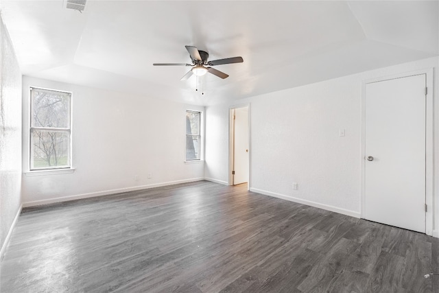 empty room featuring vaulted ceiling, ceiling fan, and dark hardwood / wood-style flooring