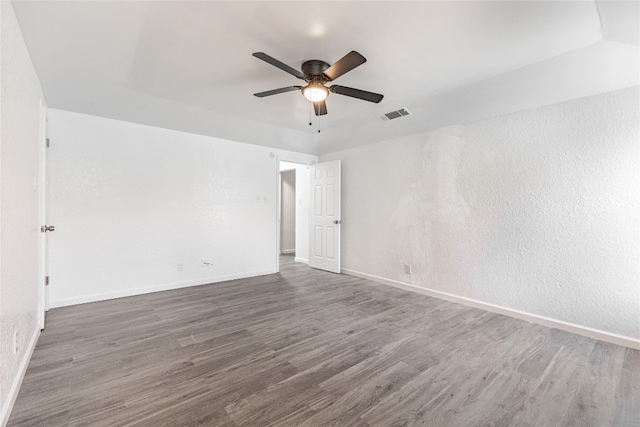 spare room with ceiling fan and dark wood-type flooring