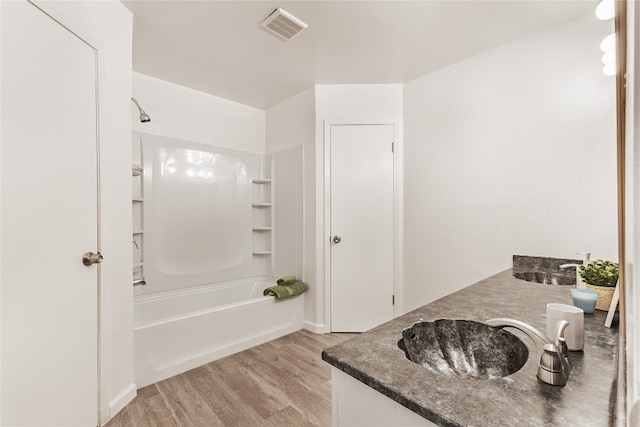 bathroom featuring vanity, shower / bath combination, and hardwood / wood-style flooring