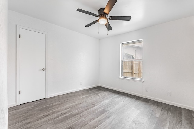 empty room with light hardwood / wood-style flooring and ceiling fan