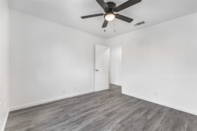 unfurnished room featuring ceiling fan and dark wood-type flooring