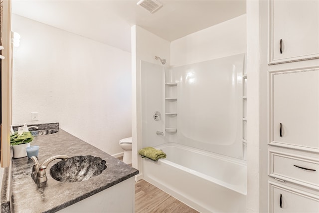 full bathroom featuring vanity, toilet, tub / shower combination, and hardwood / wood-style floors