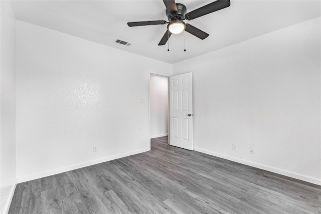 unfurnished room featuring dark hardwood / wood-style flooring and ceiling fan