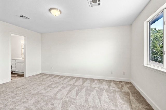 unfurnished room with light colored carpet