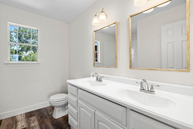 bathroom with vanity, hardwood / wood-style flooring, and toilet