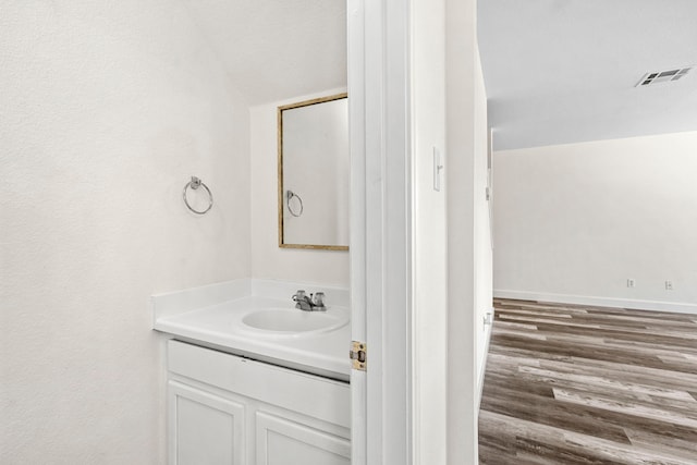 bathroom with vanity and lofted ceiling