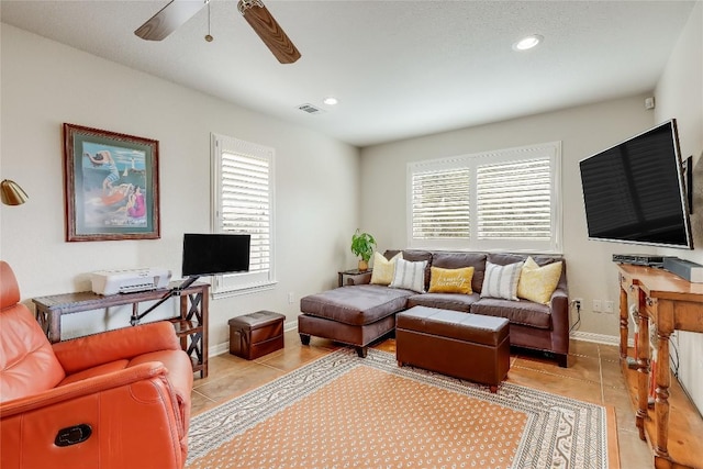 living area featuring light tile patterned floors, ceiling fan, visible vents, and recessed lighting