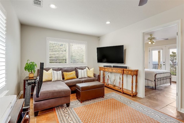 living room with a wealth of natural light, french doors, visible vents, and recessed lighting