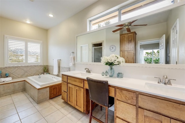 bathroom featuring a stall shower, double vanity, a sink, and tile patterned floors