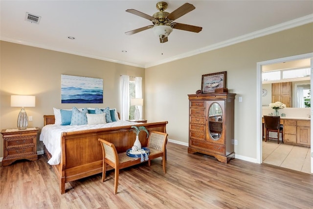 bedroom with light wood-style floors, visible vents, crown molding, and baseboards