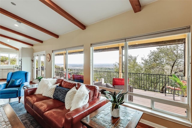 living area featuring lofted ceiling with beams