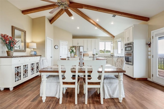 dining room with lofted ceiling with beams, wood finished floors, visible vents, and recessed lighting