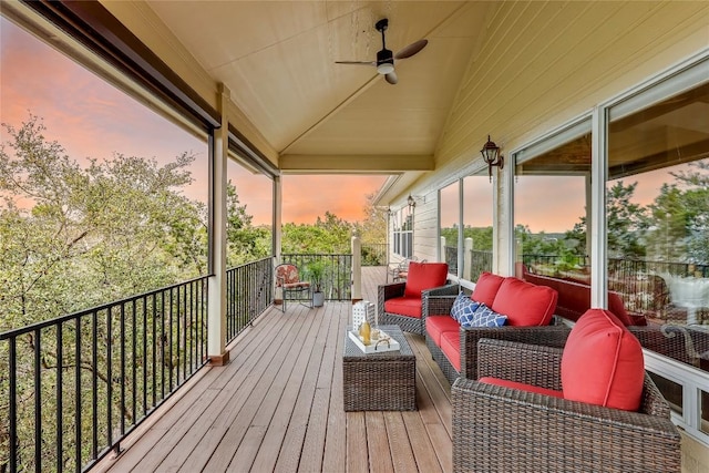 deck at dusk featuring a ceiling fan and an outdoor living space